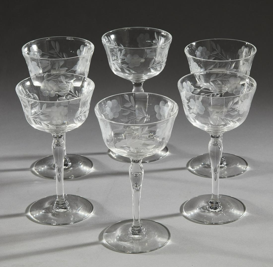 (6) Etched crystal wine glasses: (6) Etched crystal wine glasses, executed in clear crystal, each having a shallow bell shaped bowl decorated with an etched flower sprig, rising on a cylindrical baluster stem, terminating to a splaye