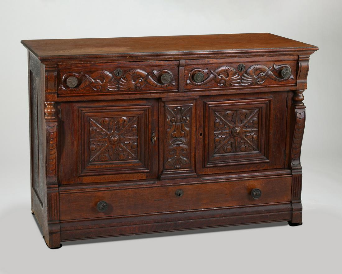 Early 20th c. Renaissance Revival style oak chest: Renaissance Revival style oak chest, early 20th century, having two frieze drawers relief carved with contesting sea creatures, rising on doors with naturalistic panels flanking a stylized Green Man m