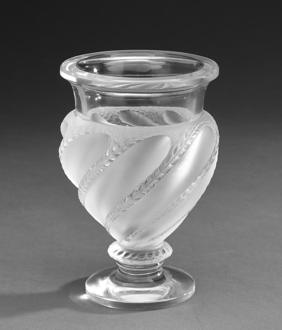 Lalique crystal Ermenonville vase: Lalique crystal Ermenonville vase, of urn form, executed in clear and satin glass, the body having a twist pattern accented with cut fines, the whole rising on a circular foot, maker marked, 6"h x 4"d