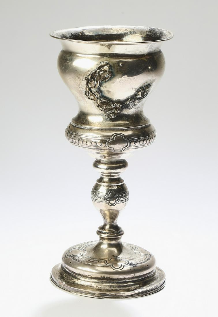 19th c Continental silver chalice: Continental silver chalice, late 19th century, having a flared rim above a waisted bowl with an applied wreath, the whole rising on a baluster form standard and resting on a circular foot with quatref