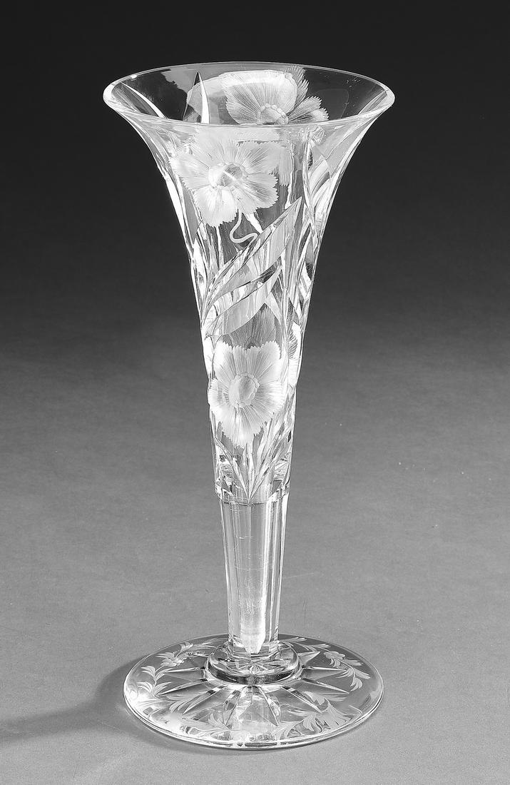 Hawkes intaglio cut glass trumpet vase: Hawkes intaglio cut glass trumpet vase, cut with flowers and swirling leaves, tapering to a faceted stem and a round foot with an etched floral wreath, having an acid etched mark underneath, 9.75"h x 