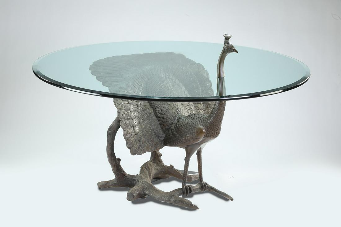 Sculptural bronze peacock center table with glass top: Sculptural bronze peacock center table with beveled glass top, having the head of the male peacock rising on the circular beveled edge surface, surmounting the neck and full body of the highly figured
