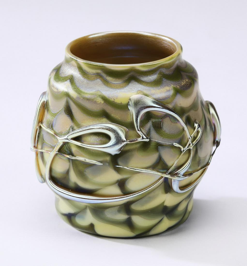 Miniature L. C. Tiffany style art glass vase: Miniature L. C. Tiffany style favrile art glass vase, having a combed design in hues of moss, buttercream and silver, with applied gold iridescent stringing, marked 'L. C. Tiffany,' to underside, 3"h 