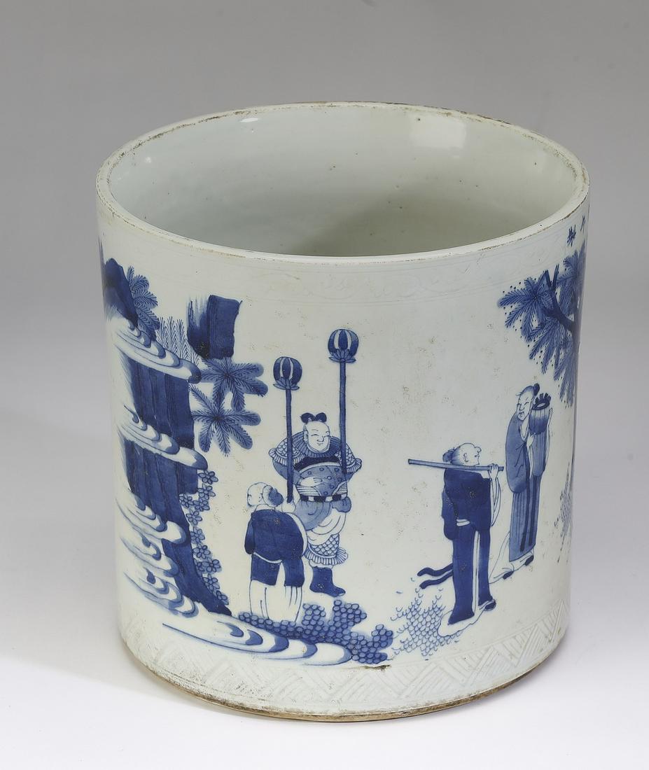 Chinese Ming style brush pot with courtiers: Chinese Ming style blue and white brush pot, of cylinder form, decorated with a scene of courtiers enjoying outdoor pursuits while attended by servants, having a blue underglaze six character Xuande m