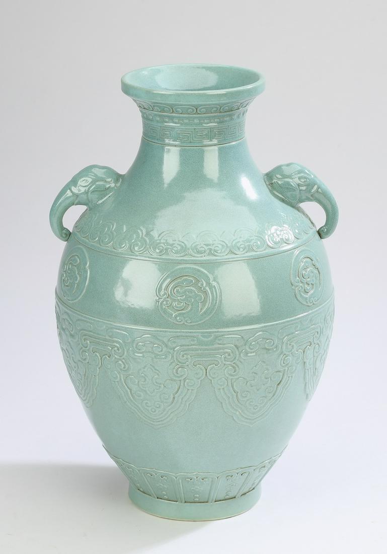 Chinese turquoise glazed Hu vase: Chinese turquoise glazed Hu vase, having a trumpet neck with molded ruyi and leiwen bands flanked by elephant head handles, the body molded with Ming style dragon roundels and lappet bands, the whole 