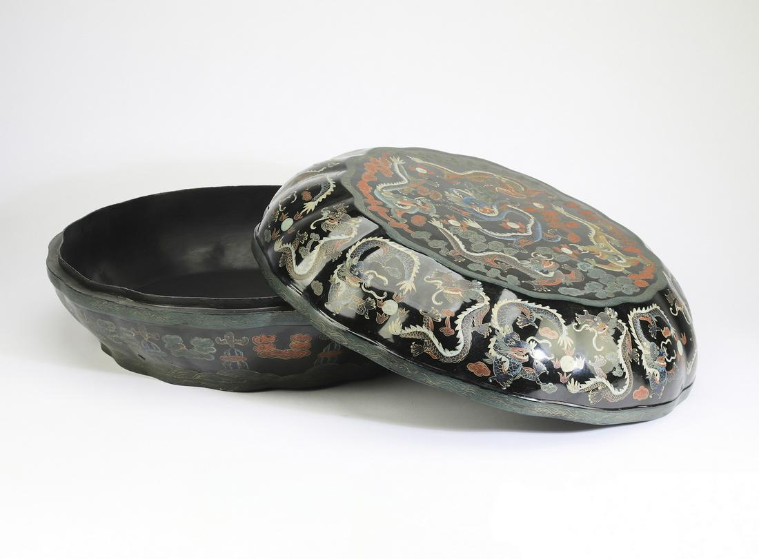 Chinese tianqi style lacquer dragon box, 18"w: Chinese tianqi style lacquer dragon box, of discoid form with scalloped sides, the top centering a writhing five clawed dragon contesting pearls of wisdom amidst auspicious cloud forms, framed by writ