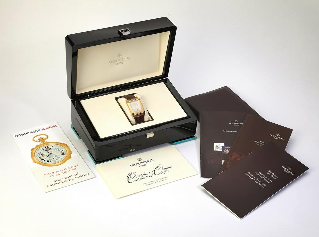 Deco Patek Philippe Gondolo 18k, 5111 J: Deco Patek Philippe Gondolo 5111 J 18k gold 32mm watch, featuring a tank case with a sapphire crystal above a silvered gold dial with stick markers and a 12-hour dial, having a manual mechanism, the w