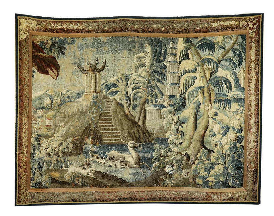 18th c. Continental hand woven verdure tapestry: Continental hand woven wool verdure tapestry, 18th century, depicting a stag hunt through an exotic jungle dotted with pagodas and temples, executed in greens, grays, and chocolate browns, with an alt