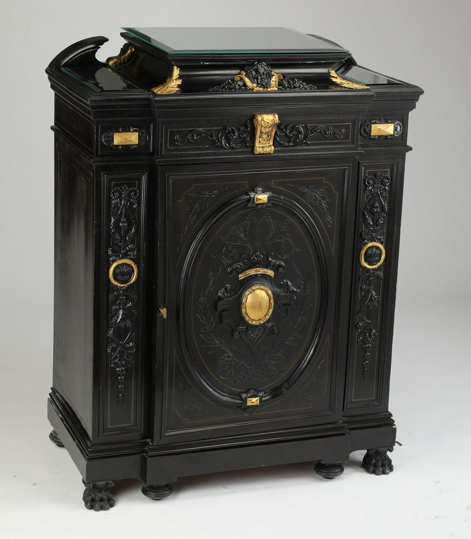 French Empire style carved and ebonized cabinet: Early 20th century French Empire style ebonized cabinet, the stepped top with broken crest and three conforming mirror panel toppers, above the conforming one door case centering a gilt corbel leading