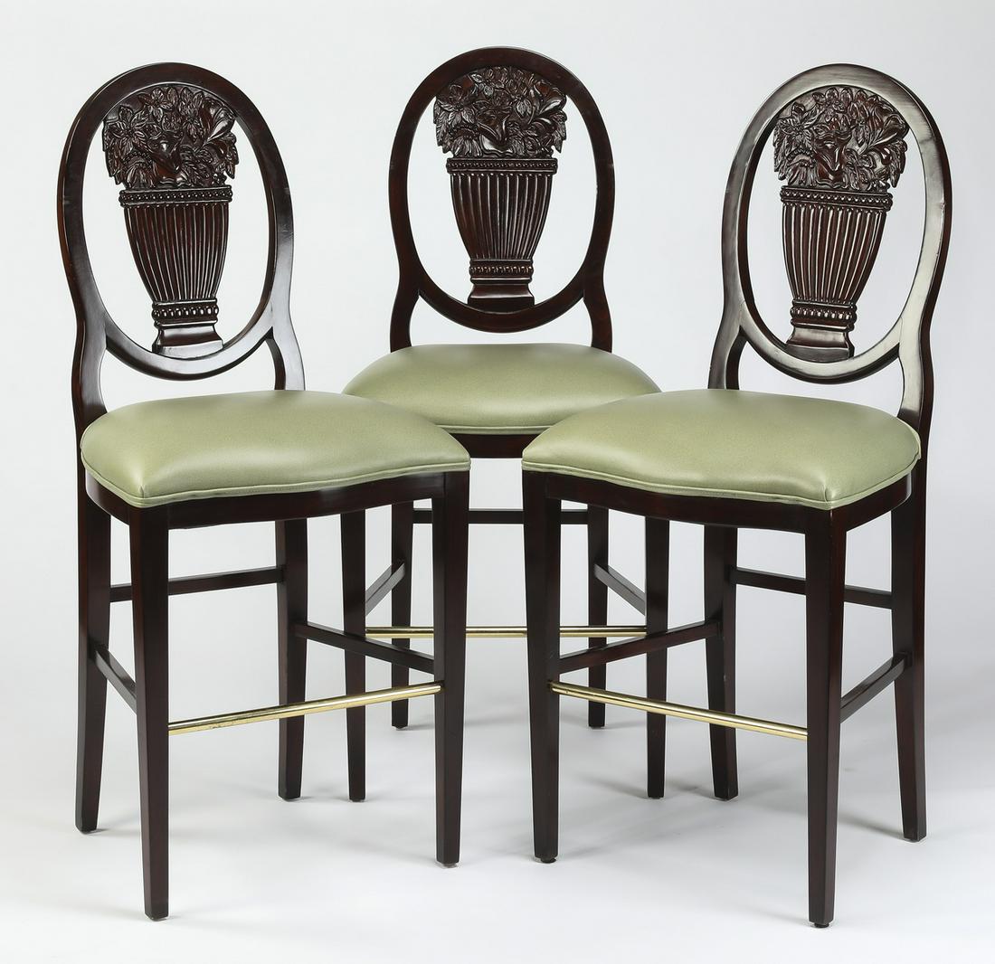(3) Hepplewhite style mahogany barstools, 50"h: Set of three Hepplewhite style mahogany barstools, having oval backs with carved splats in the form of flower filled urns, above seats upholstered in pale green faux leather, each rising on tapering s
