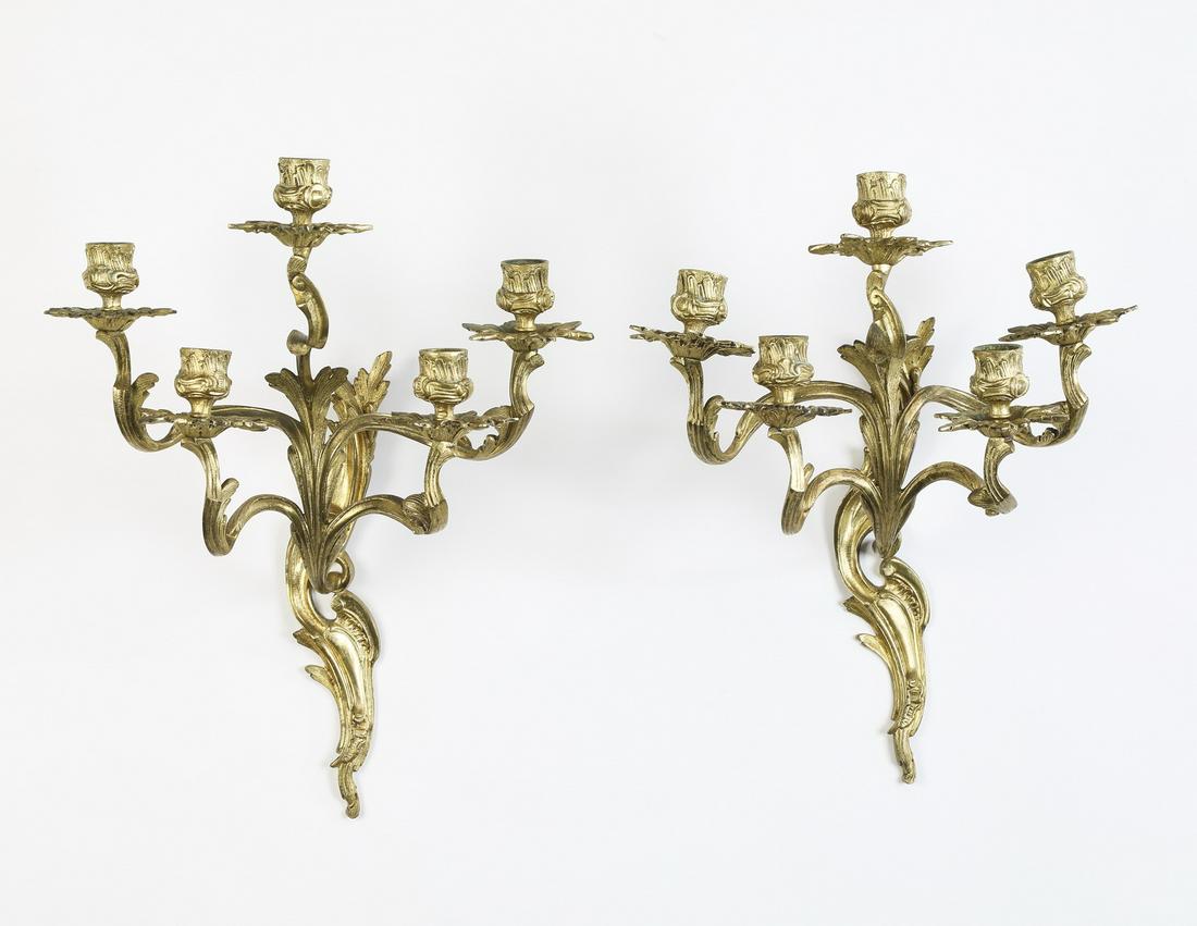 (2) 19th c. Louis XV style gilt bronze sconces: Pair of French five-light gilt bronze sconces in the Louis XV taste, mid 19th century, each having a center candle cup over an acanthus standard issuing four sinuous arms, terminating to a foliate pen