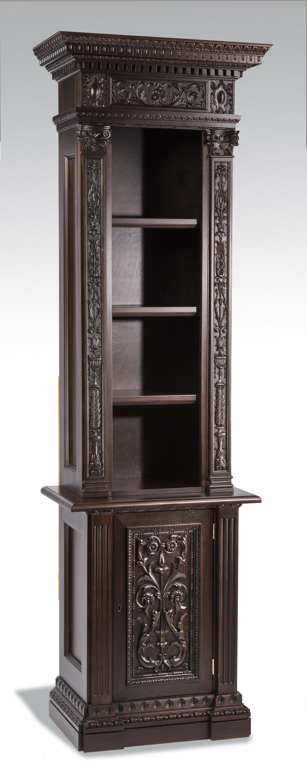 Continental carved walnut display cabinet: Continental carved walnut display cabinet, having a gadrooned cornice, above a band of carved scrollwork flanked by cabochon motif end caps, centering three shelves flanked by foliate carved pilasters