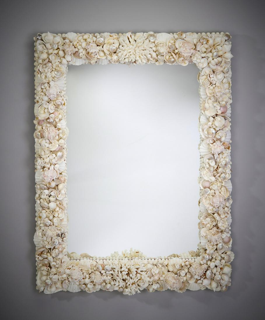 Contemporary coral and shell mirror: Contemporary coral and shell mirror, the crest centering a coral specimen, and ornamented throughout with light colored shells, mirror 31.5"h x 21.5"w, overall size with frame 41"h x 31"w x 4"d.
