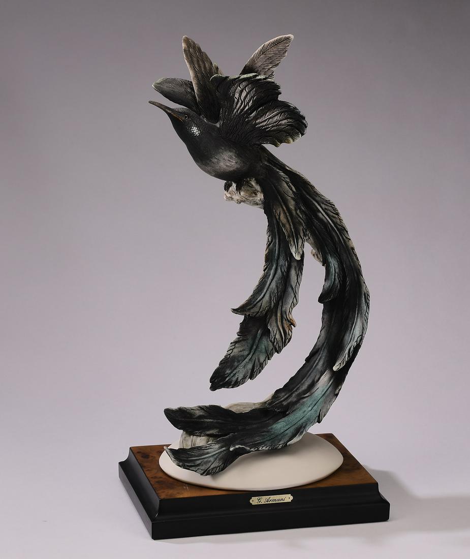 Giuseppe Armani sculpture of a bird of paradise: Giuseppe Armani wildlife sculpture, 1990, depicting a bird of paradise in flight with C-shaped long tail feathers, maker marked and signed, 14"h x 7.25"w x 5"d.
