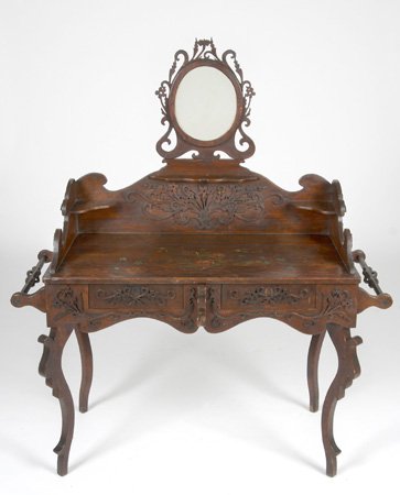 19th century French dressing table: 19th century French Provincial carved and decorated dressing table with pierce carved oval mirror and flanking towel racks, 59"h x 48"w x 22"d.