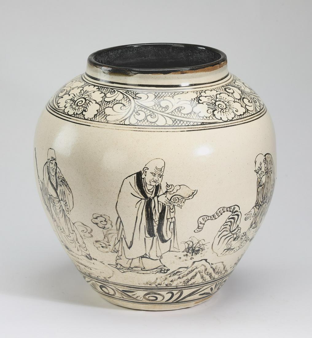 Chinese cizhou style black and cream jar w/ deities: Chinese cizhou style black and cream jar, having a black rim above a wide floral band, the shouldered body decorated with Chinese deities, the whole tapering to a scrolling band, 15"h x 11.5"w.