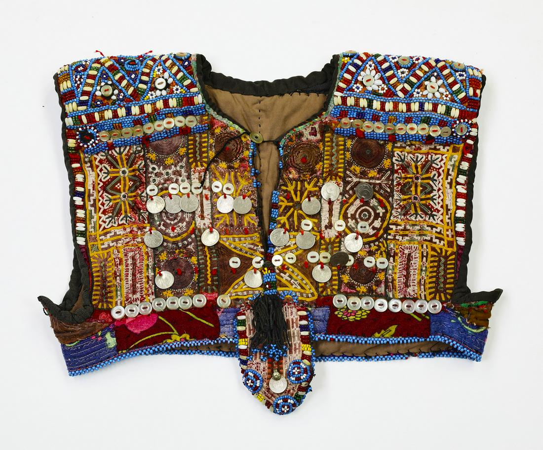 Central Asia hand embroidered child's vest: Central Asia hand embroidered child's vest, early to mid 20th century, executed in cotton, silk, glass beads, metal, and mother of pearl buttons, the cotton and silk foundation embroidered in chain st
