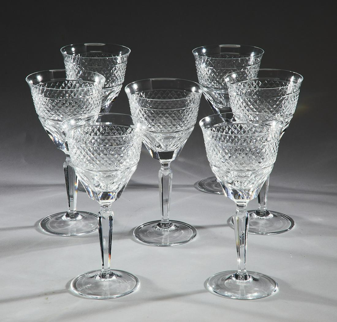 (7) Continental cut crystal wine glasses: (7) Continental cut crystal wine glasses, executed in clear crystal, each having a bell shaped bowl decorated with a band of diamond cuts, rising on a six sided tapering stem terminating to a splayed 