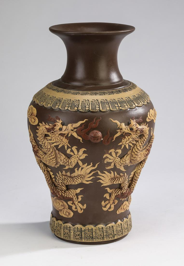 Chinese zisha clay dragon vase: Chinese zisha clay dragon vase of baluster form, having a trumpet neck above applied leiwen and lappet bands, the body decorated on one side with applied five clawed writhing dragons contesting pearls