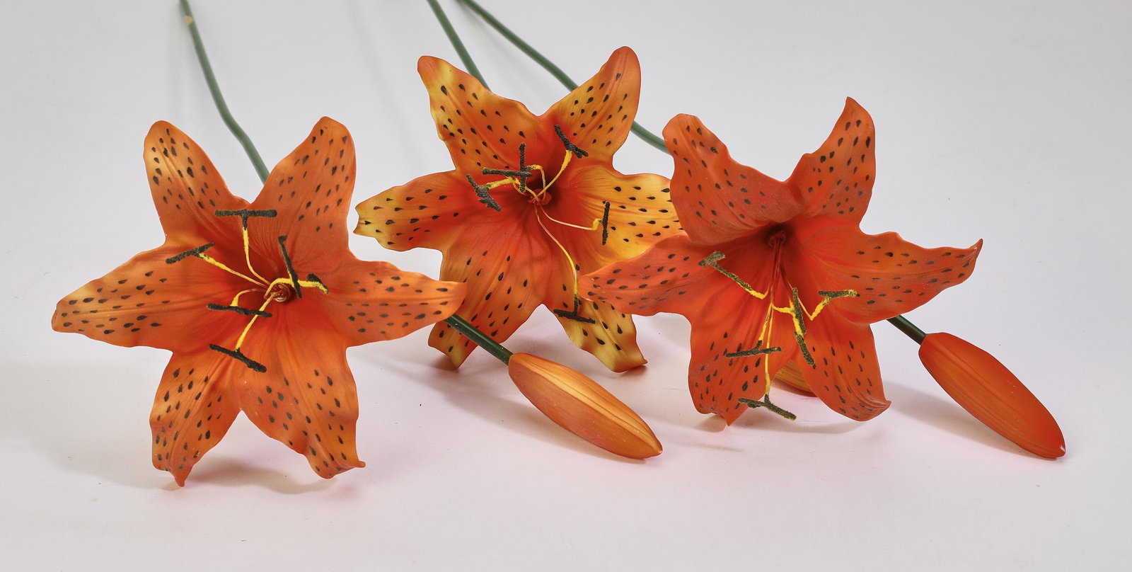 Group of (3) porcelain lillies: Group of (3) porcelain lillies, late 20th century, in hues of orange, 18.25"l x 7"w x 4.25"d.