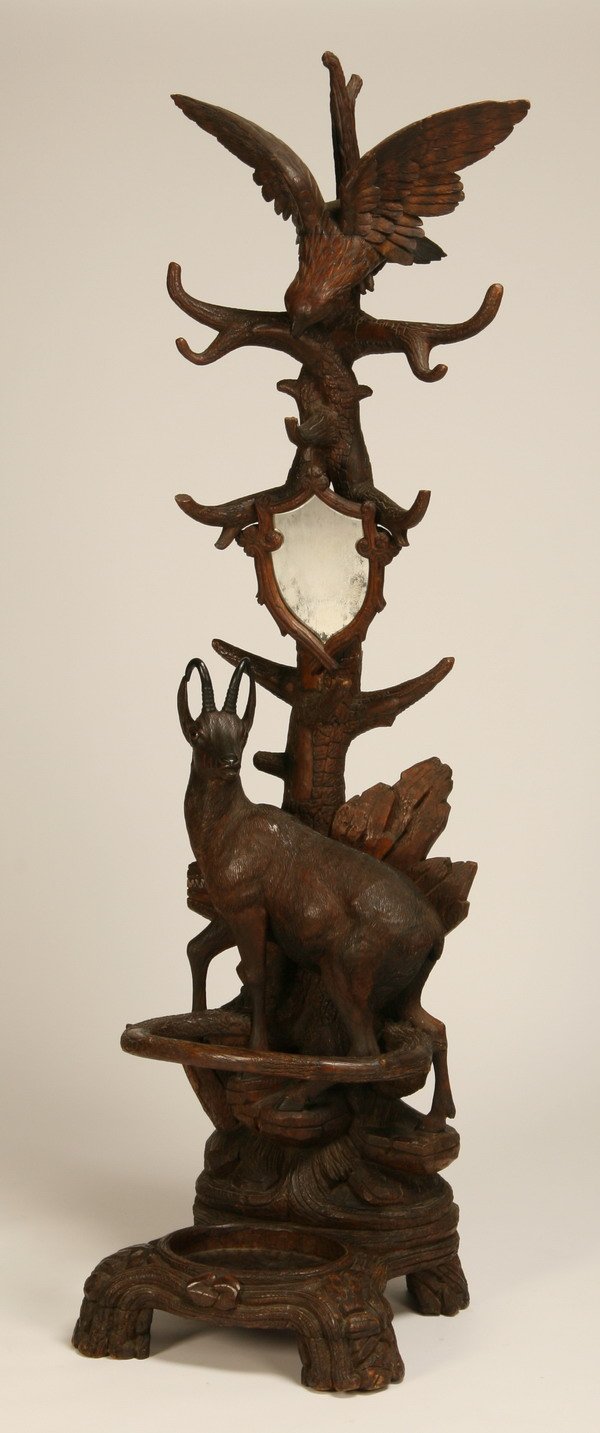 19th century Black Forest hall tree: Late 19th century carved black walnut Black Forest hall tree, comprised of a fully formed mountain goat surmounted by an eagle preparing for flight, complete with mirror and umbrella stand, 88"h x 22"