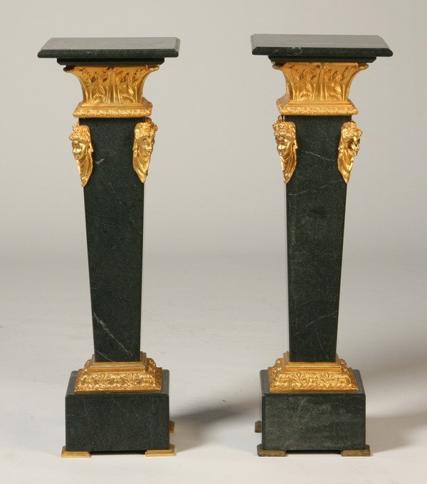 Pair of bronze mounted verde marble pedestals: Pair of bronze mounted verde marble tapering pedestals with dore' bronze maiden masks, 41"h x 13.5" square top.