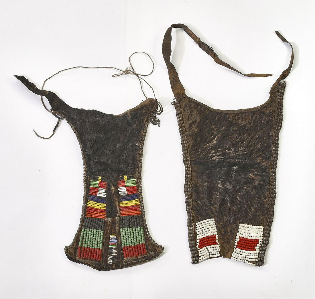 (2) Ethiopian hair on hide aprons w/ glass beads: Two Ethiopian hair on hide aprons, likely Hamar peoples, early 20th century, each of waisted rectangular from with geometric glass bead decoration at bottom, and with straps, first 17"l x 9"w, with st