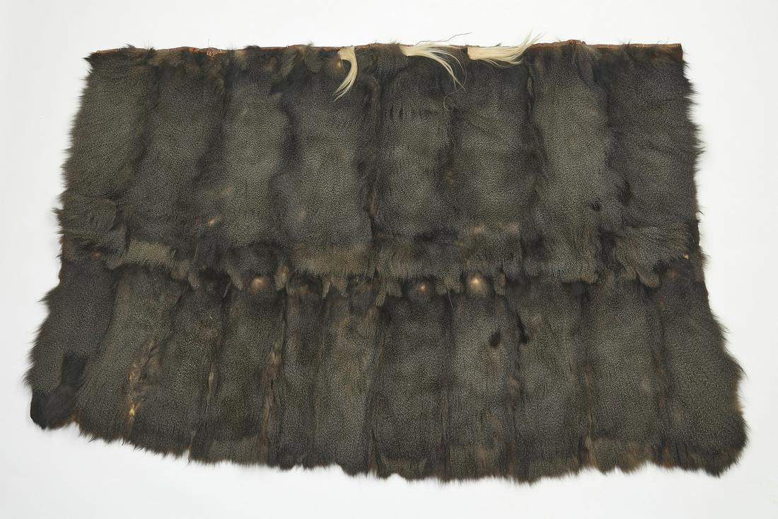 Hair on hide beaded goat skin wrap, 78"w: Hair on hide goat skin wrap, likely Maasai peoples, Kenya, of rectangular form, having applied tufts of white fur and glass beads at the edge,48"h x 78"w.