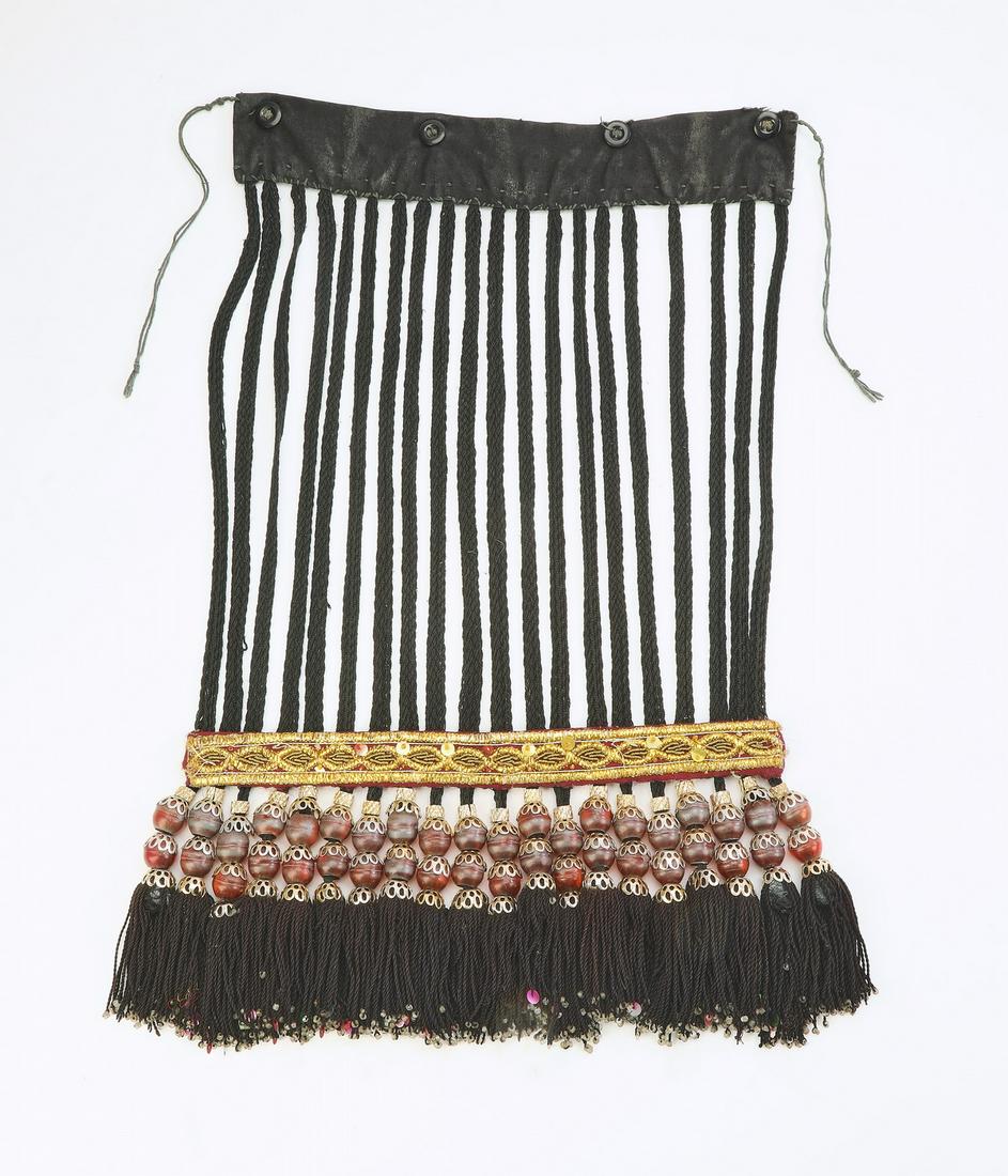 Uzbek cotton and bead veil, early 20th c.: Uzbek veil, early 20th century, executed in cotton and glass beads, having braided black cotton fringe caught at the bottom edge by gold trim and a double row of glass beads, the whole terminating to 