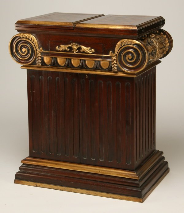 Carved mahogany pedestal-shaped bar: Carved and parcel gilt mahogany bar in the form of a Corinthian pedestal, the top opening to form a serving bar, with concealed storage for glasses and liquor bottles, 42"h x 32"w x 21"d (64"w at top 