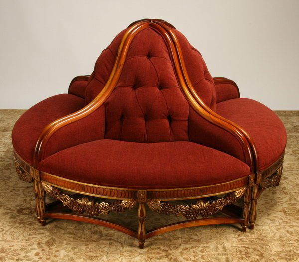 Carved and parcel gilt four section roundabout: Carved and parcel gilt mahogany roundabout, comprised of four separate sections that can used together or as individual corner chairs, upholstered in burgandy chenille with tufted backs, 41"h x 66" di