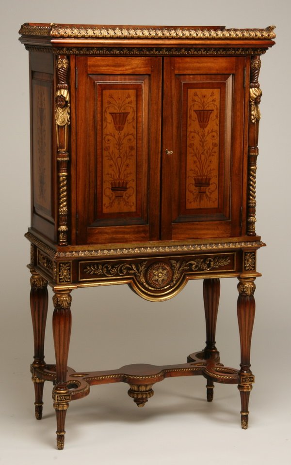 20th c. carved mahogany cabinet: Carved mahogany cabinet with hand painted Neoclassical designs and mirrored interior, 61"h x 34"w x 18"d.