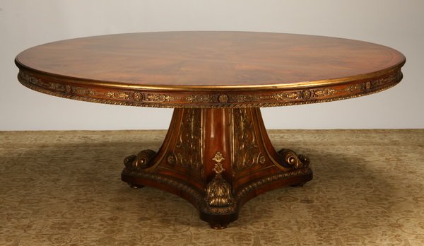 Carved and parcel gilt dining table: George III-style carved and parcel gilt mahogany dining table on tripod base, 31"h x 77"diam.
