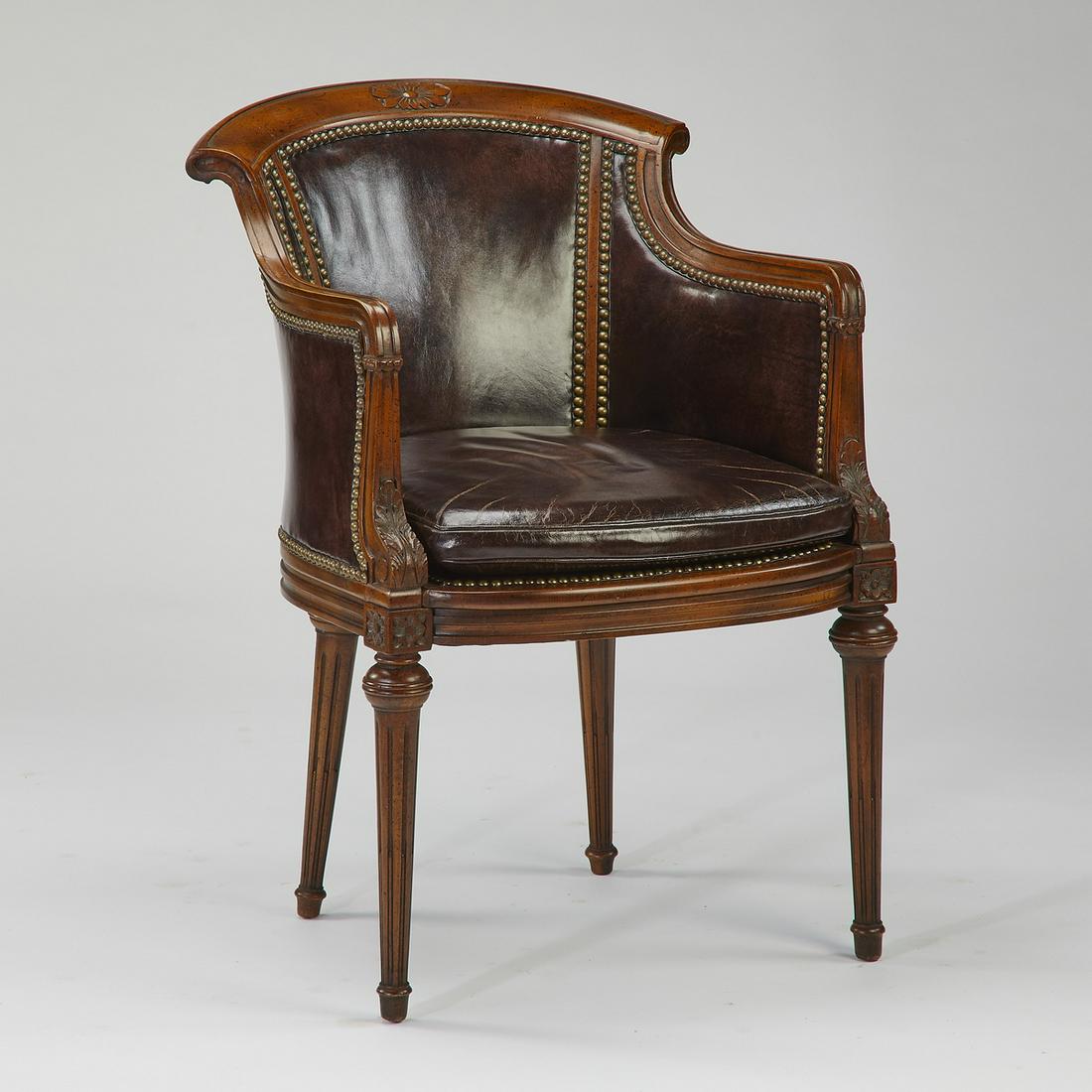 Early 20th c.English Regency style leather club chair: English Regency style leather and walnut club chair, early 20th century, having a curved and arched wooden crest rail, over a conforming back, the seat having a curved and reeded front rail, upholster