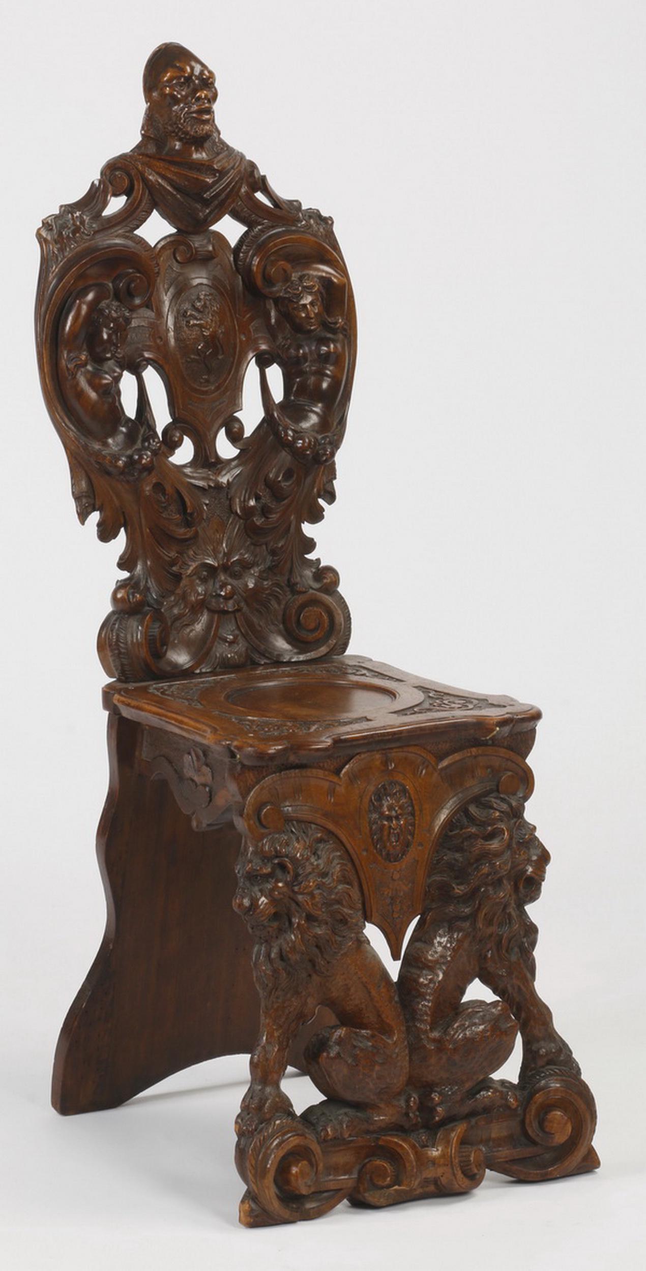 19th c. carved Italian hall chair: 19th century Italian Renaissance Revival ornately carved hall chair, the pierce carved back surmounted by a male bust, above a pair of female grotesques flanking a lion within a shield, the seat raise