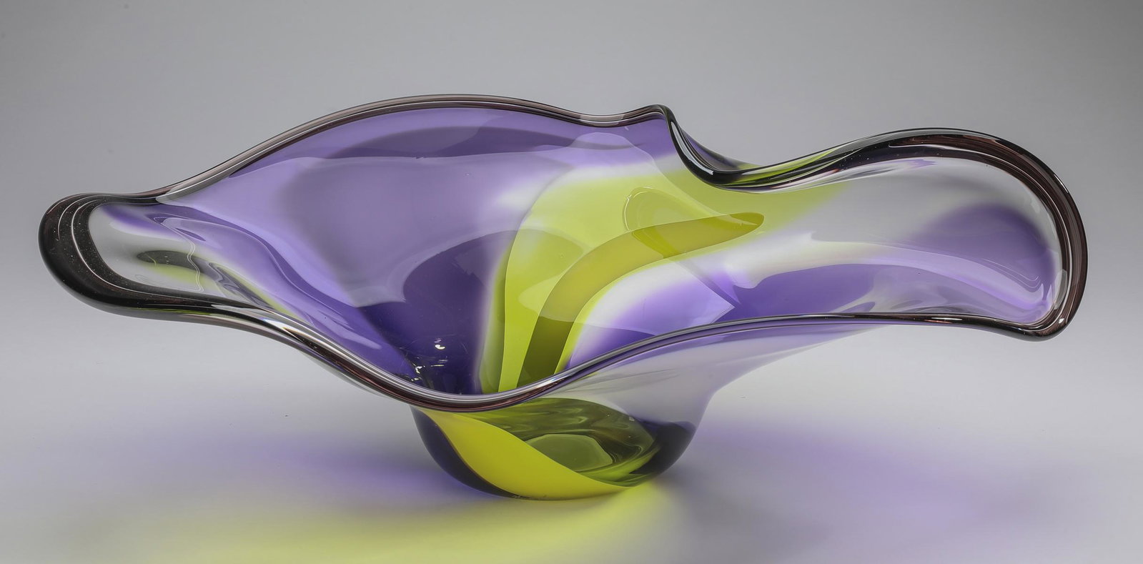 Rick & Janet Nicholson art glass center bowl, 24"w: Rick & Janet Nicholson art glass center bowl, 2000, executed in lavender, citron, and clear glass, having a freeform undulating rim with flowing color blocks, tapering to a circular foot, with etched 