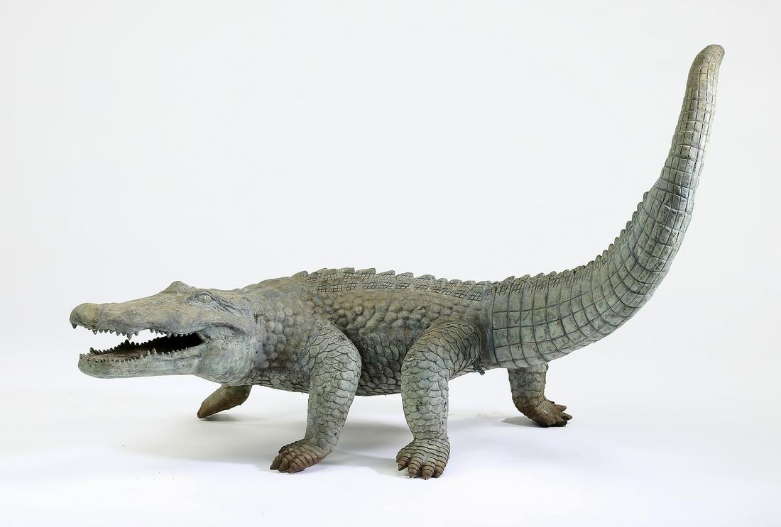 Life size bronse sculpture of an alligator: Life size bronse sculpture of an alligator, depicting the animal with tail raised and mouth open as if to bite its prey, having no apparent marks, 29.5"h x 46"l x 19"w.