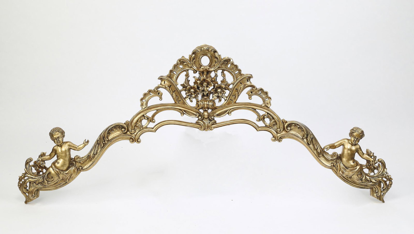 Italian pierce carved and gilt crest, 76"l: Italian pierce carved and gilt Rococo style crest with a fully formed putto at each end, 30.75"h x 76"l