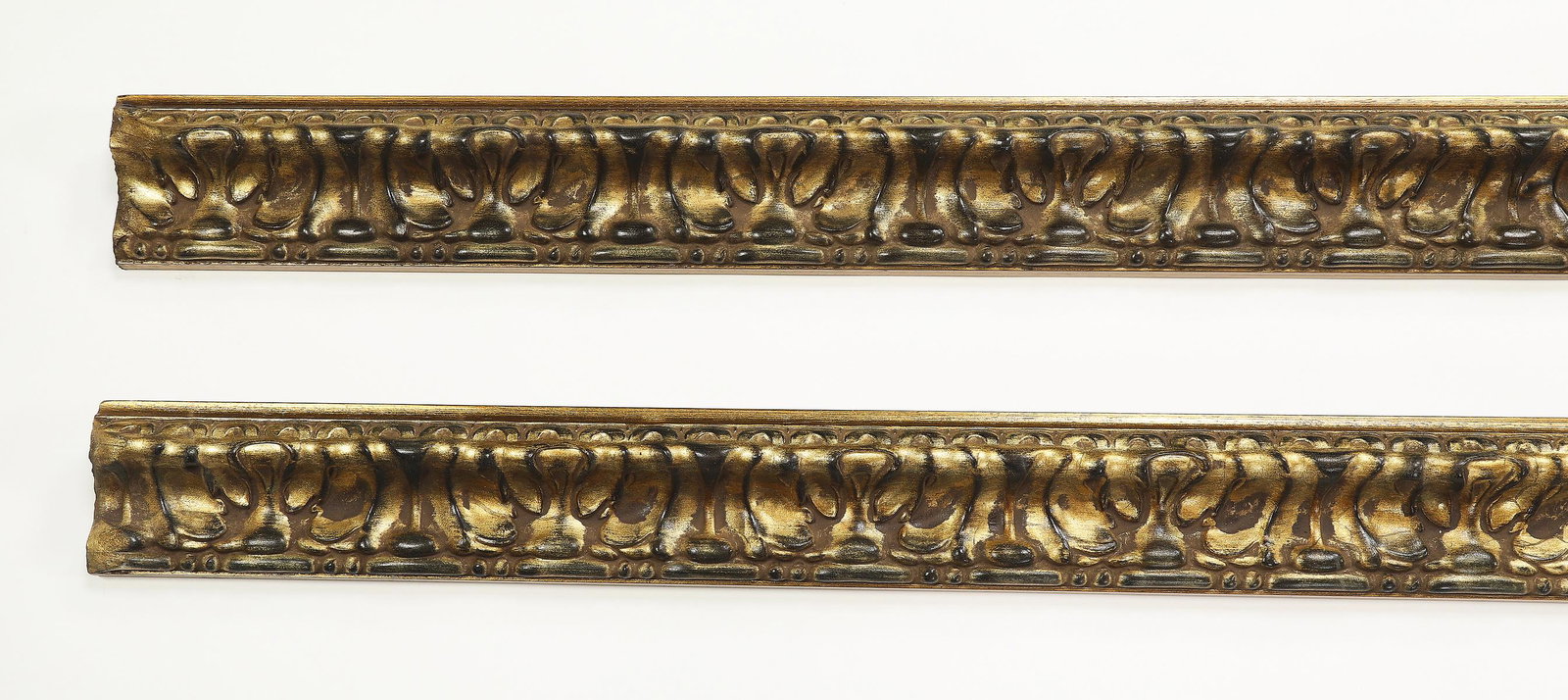 (2) Italian carved and gilt decorative moldings 119"l: Pair of Italian carved and gilt decorative moldings, each of gadrooned design, measuring 4.25"h x 118.5"l x 2.25"d.
