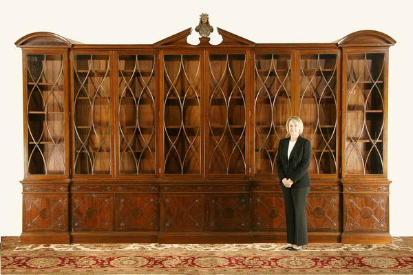 Monumental 19th c. English mahogany bookcase: 19th century English Chippendale Cuban mahogany china cabinet or bookcase with broken pediment top featuring a central bronze maiden bust, with eight mullioned doors over drawers and storage cabinets,