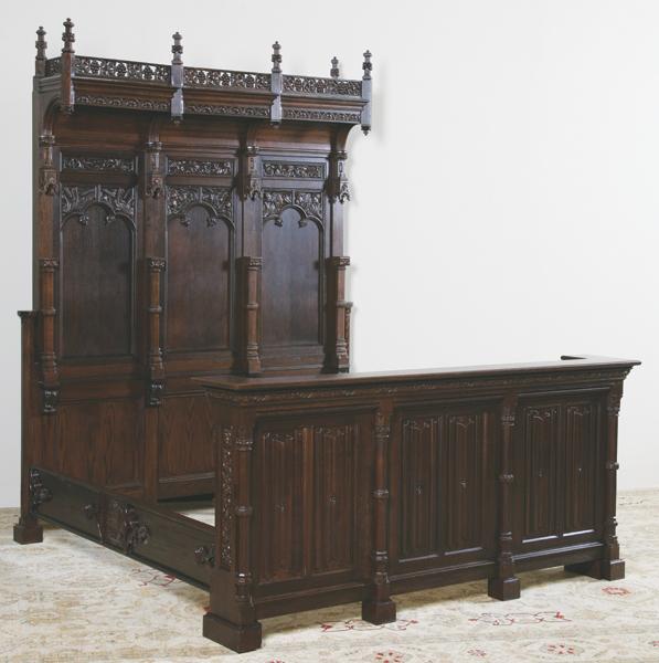 Massive 19th c. Gothic Revival king size bed: Massive 19th century French quarter sawn oak Gothic Revival king size bed with pierce carved gallery, carved spires, tongue and groove oak on the arched top, and carved linen fold paneling on the foot
