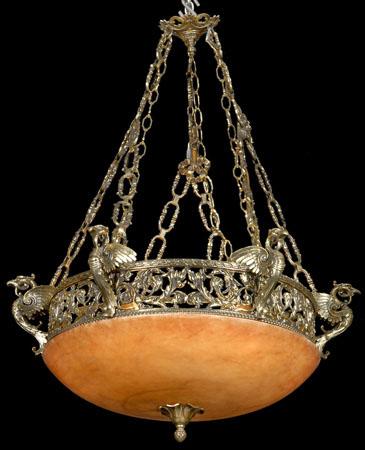 19th c. bronze and alabaster chandelier: Late 19th century bronze chandelier with intricately sculpted bronze band encircled by winged hawk term figures, all suspended by bronze linked chains, with a rouge alabaster dome, 39"h x 34"w.