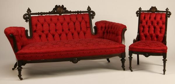 19th c. American black walnut sofa and side chair: 19th century American Renaissance Revival carved black walnut sofa and side chair upholstered in tufted scarlet damask, each with a bronze medallion at the center of the carved crestrail, sofa 39"h x 