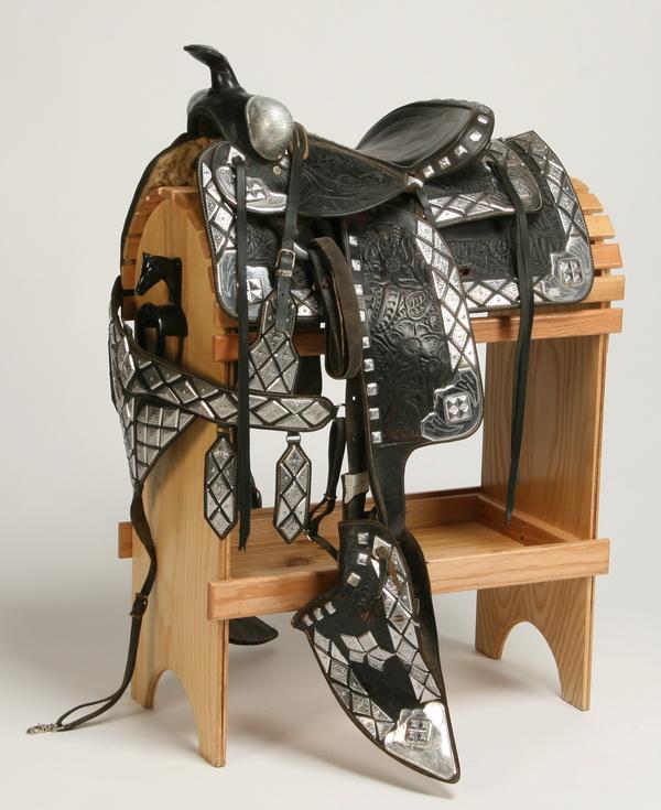 Western parade saddle by Edward Bohlin: Western parade saddle, maker marked Edward Bohlin Saddlemakers / Silversmiths, Hollywood, California. Display stand included.