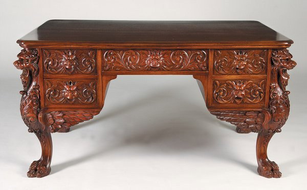 19th c. partners' desk, marked R.J. Horner: 19th century carved mahogany partners' desk featuring foliate carved drawer fronts with Green Man drawer pulls, the corners formed by fully carved winged gryphons raised on lion paw feet, maker marked