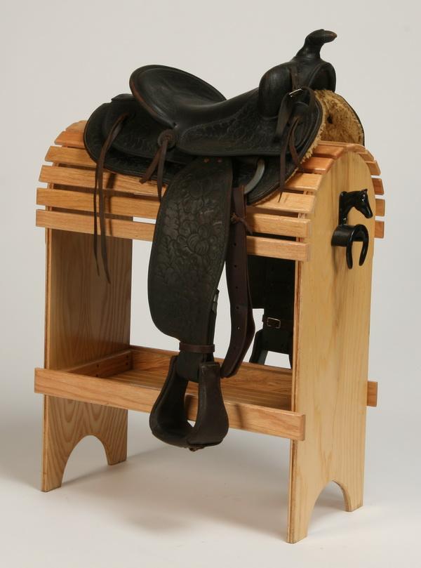 Western saddle by Rhodes: Western saddle, in black tooled leather, maker marked Rhodes, Kansas City. Display stand included.