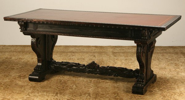 19th c. Italian carved walnut writing desk: Mid 19th century Italian Renaissance Revival-style carved walnut writing desk with gold tooled leather top bordered by an incised geometric design, with central frieze drawer, all raised on carved aca