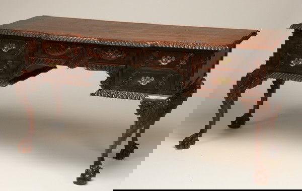 Carved mahogany credenza: Carved mahogany Chippendale-style credenza with gadrooned edge, concealed central drawer with relief carved foliate front, all raised on cabriole legs terminating in ball and claw feet, 30.5"h x 60"l