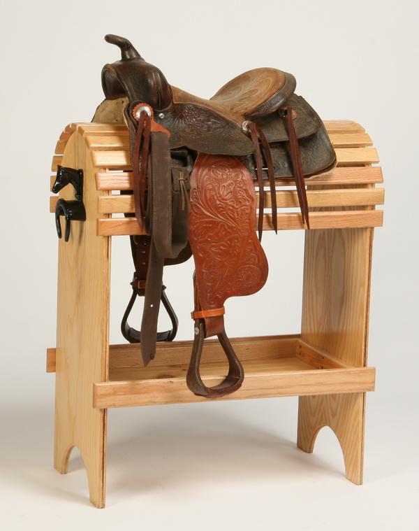 Western saddle: Western saddle in tooled leather. Display stand NOT included.