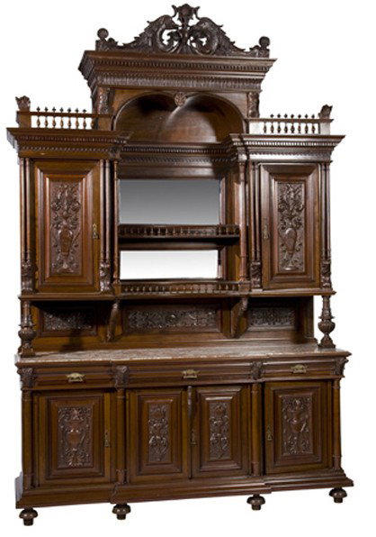 Monumental 19th c. marble top walnut buffet: Monumental 19th century carved walnut marble top buffet with central open storage surmounted by a broken arch pediment and flanked by relief carved doors, over a four door base cabinet also with relie